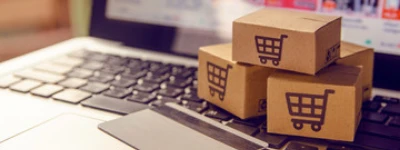 Cardboard shipping boxes with shopping cart symbols for Magento website development.