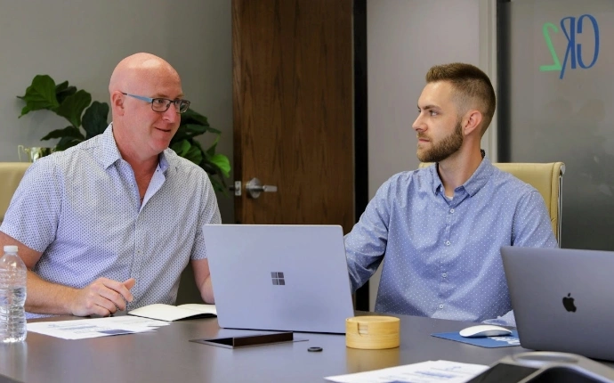OuterBox team reviewing search, paid media, and website performance with client laptops